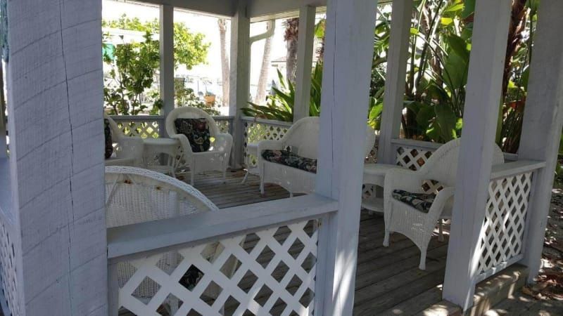 A white gazebo with white chairs and a table