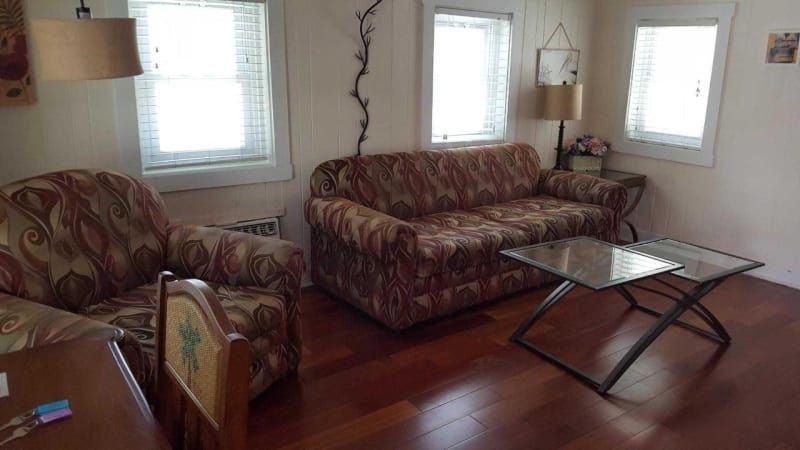 A living room with a couch , chair , and coffee table.