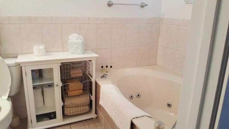 A bathroom with a jacuzzi tub and a toilet.