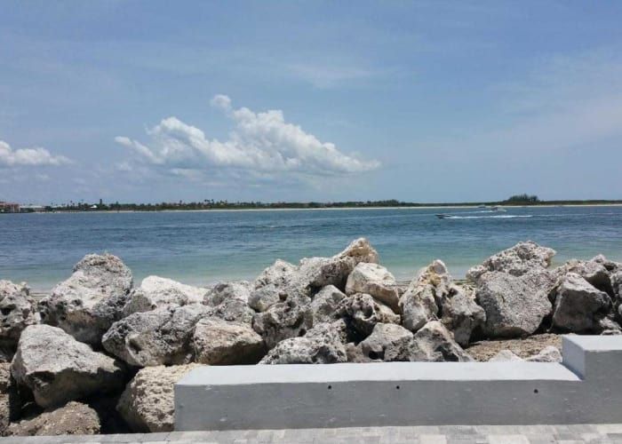 A view of a body of water with rocks in the foreground