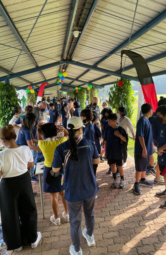 A group of people are standing under a canopy.