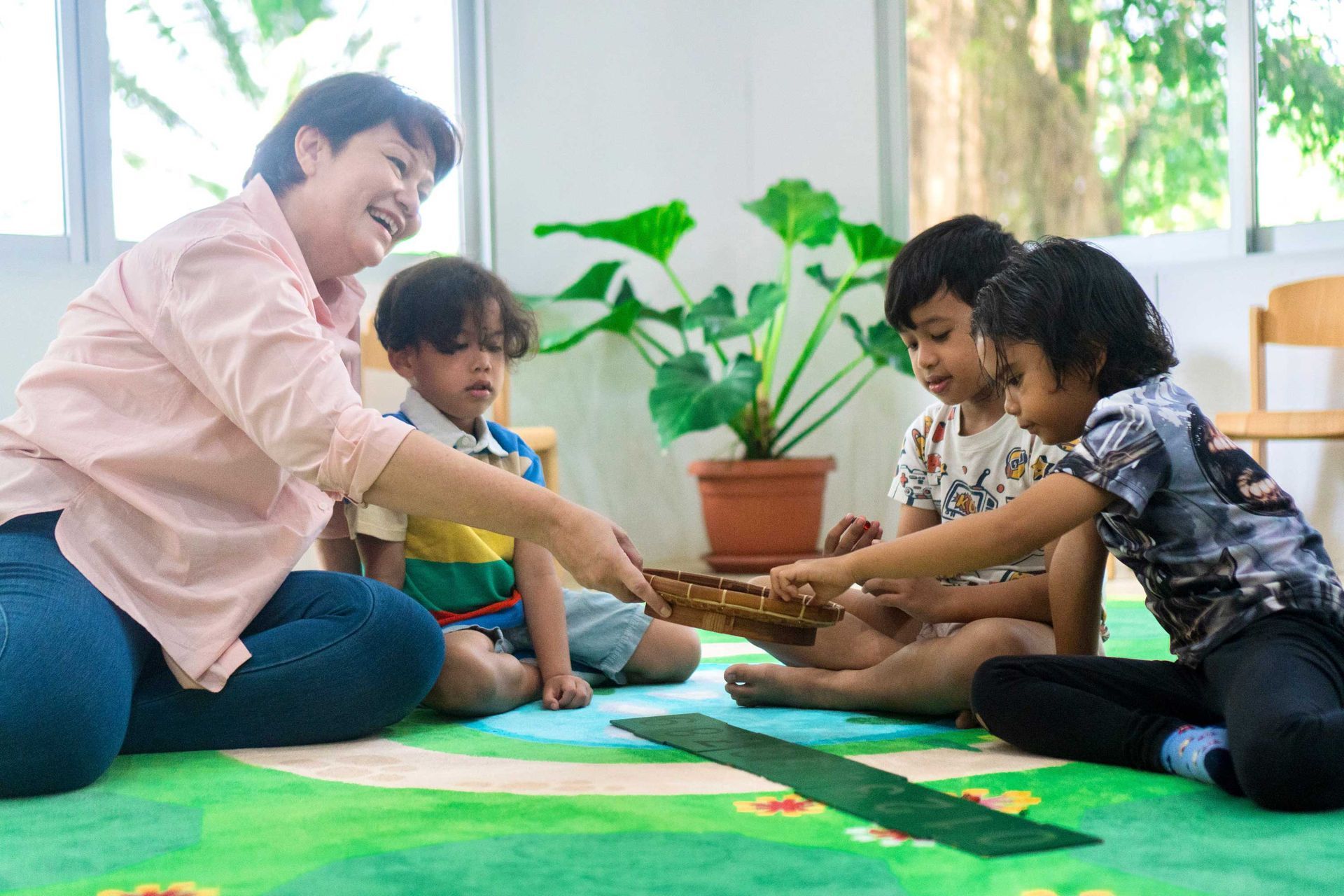 A woman is teaching a group of children how to play a musical instrument.