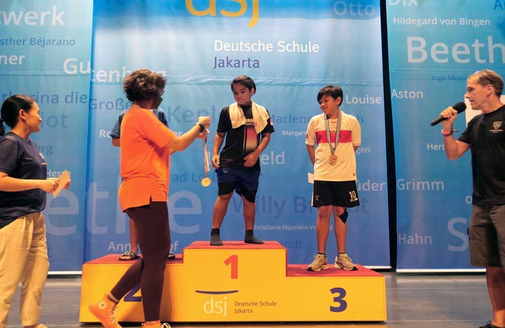 A group of people standing on a podium with the number 1 on it