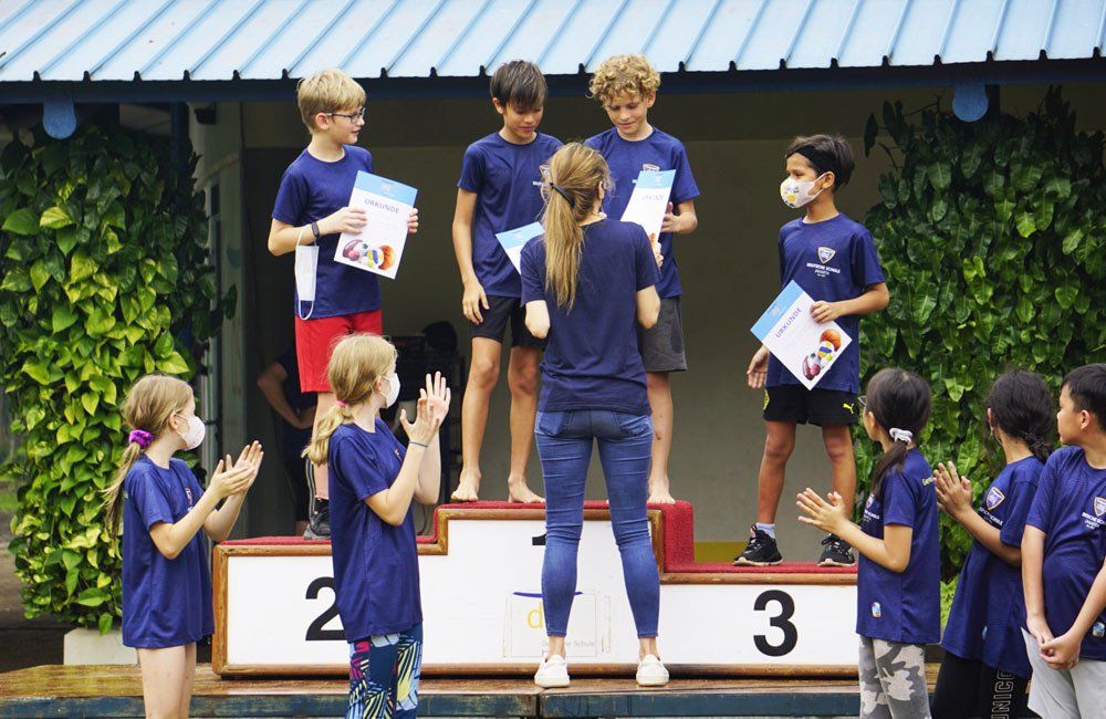 A group of children are standing on a podium.