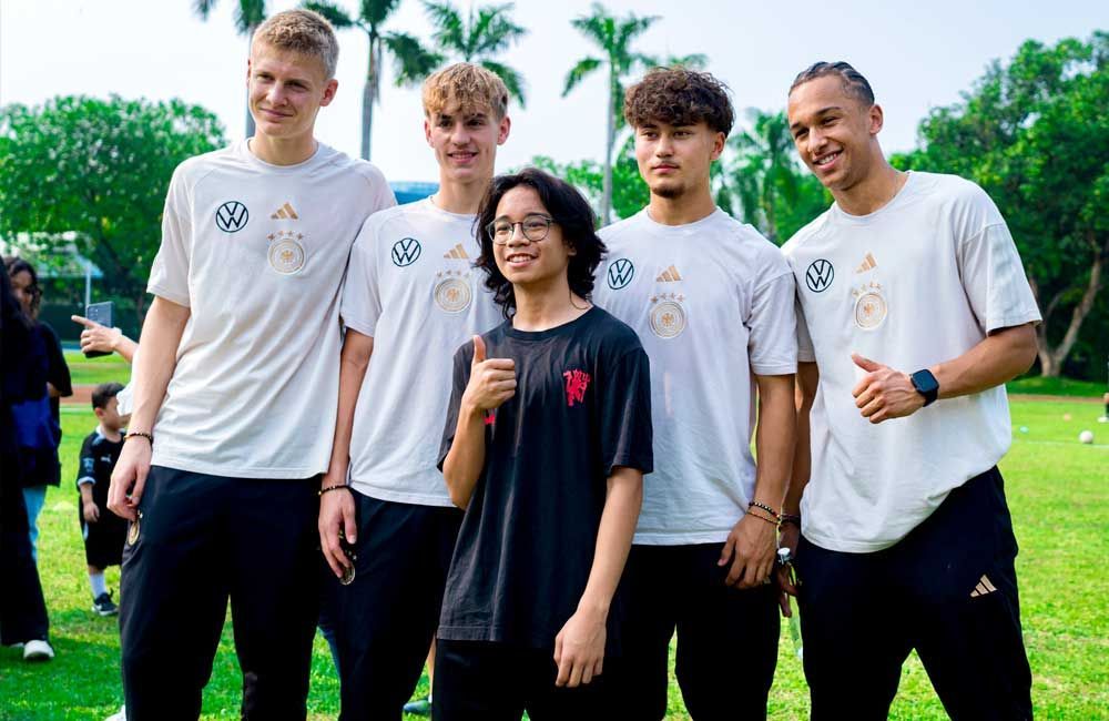 A group of young men are posing for a picture in a field.
