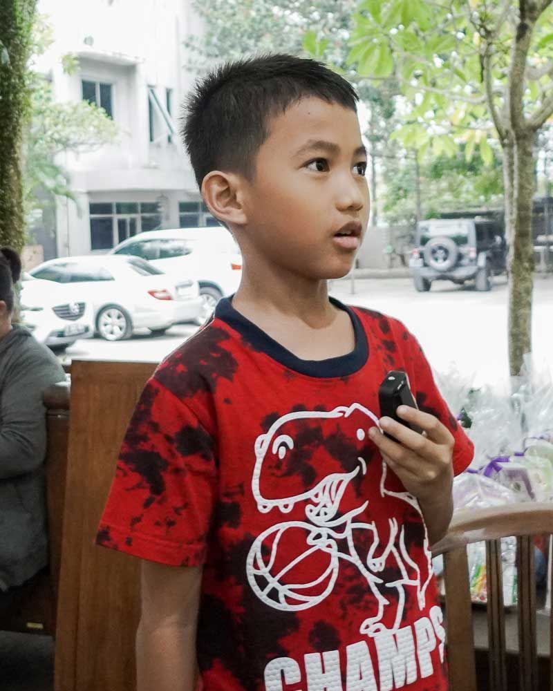 A young boy wearing a red shirt that says champs