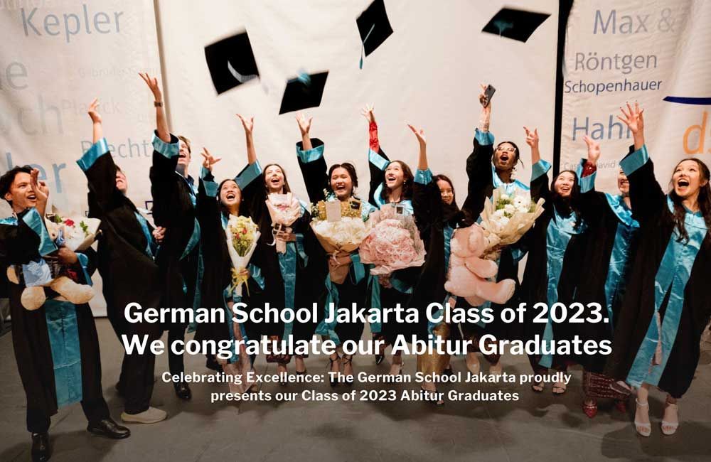 A group of graduates are throwing their caps in the air.