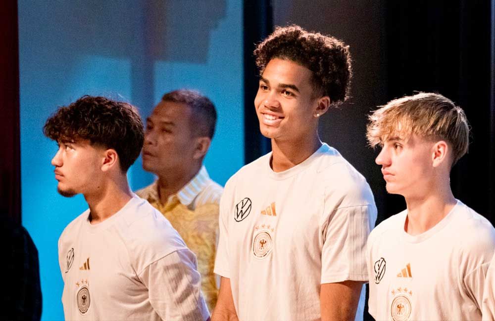 A group of young men are standing next to each other on a stage.