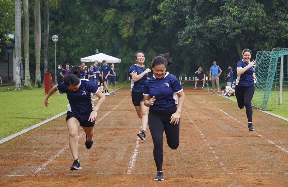 A group of women are running on a track.