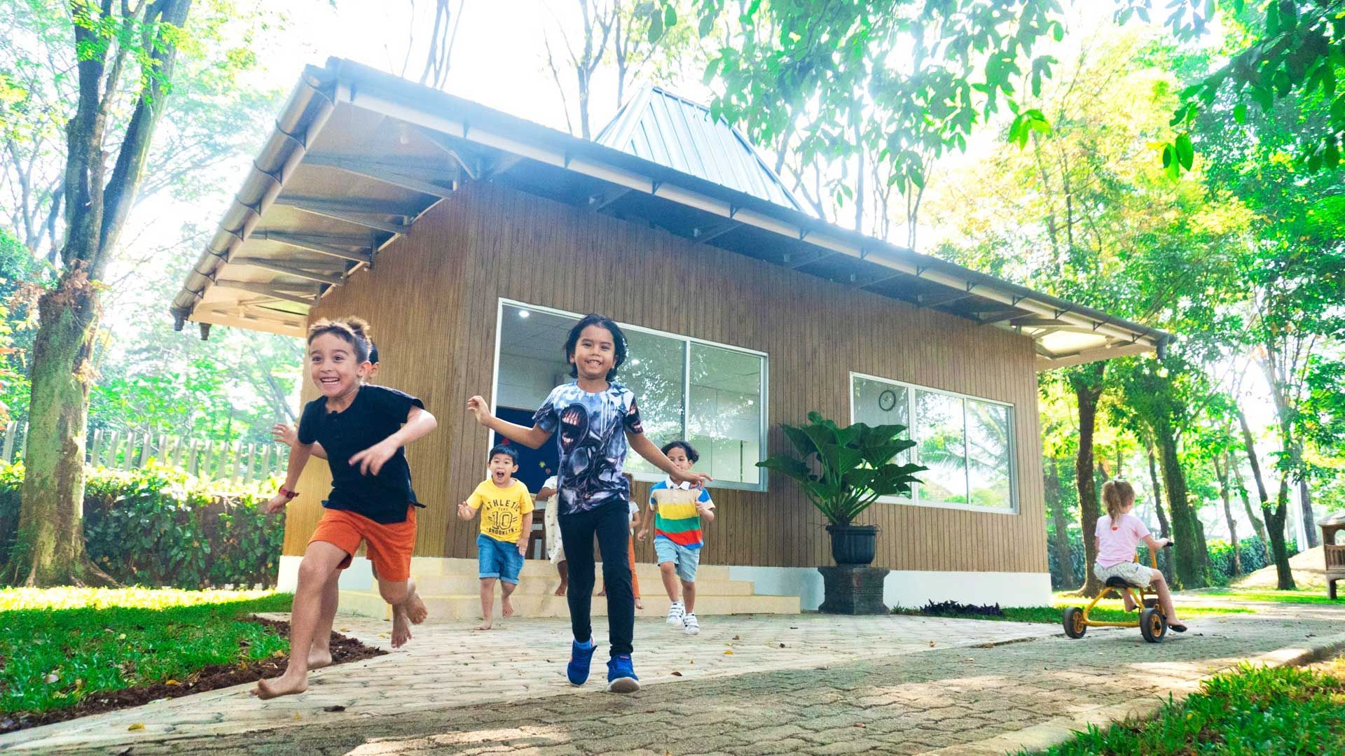 Kindergarten children happily running out from the new Garden Pavilion at the German School Jakarta