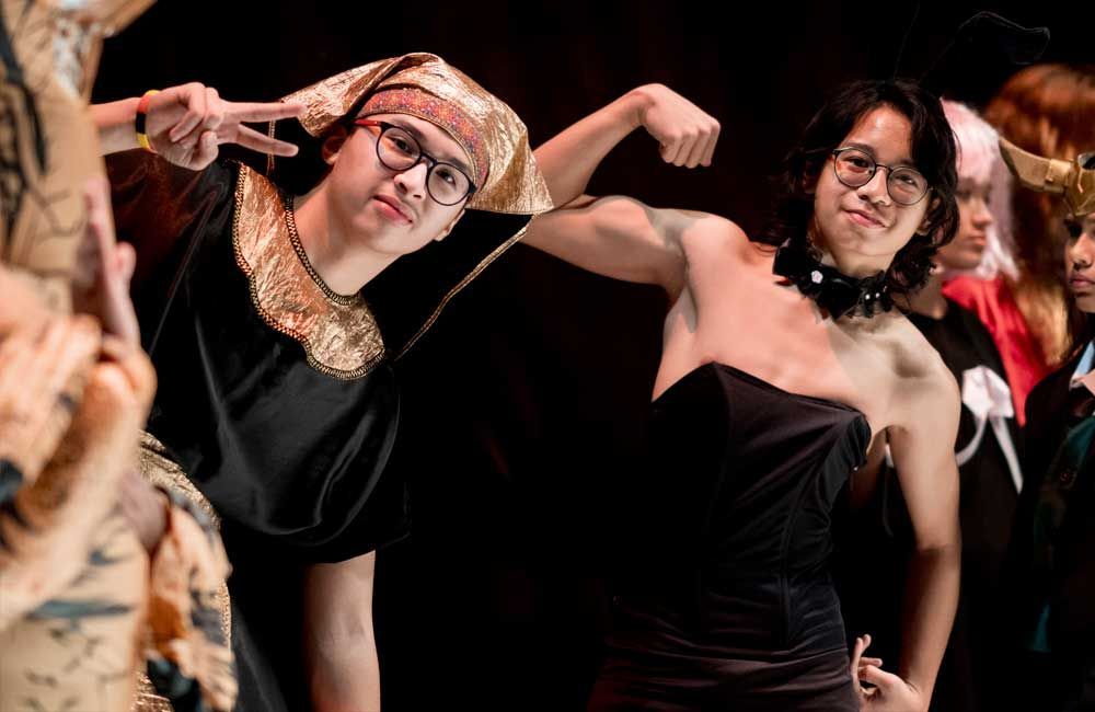 A group of people dressed in costumes are posing for a picture.