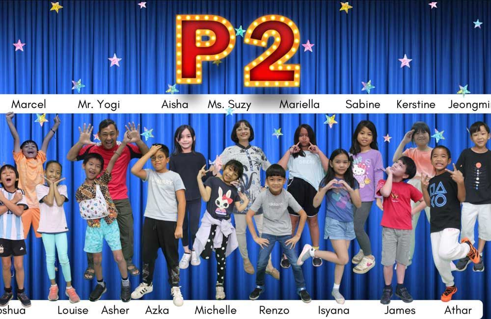 A group of children are posing for a picture in front of a blue curtain.