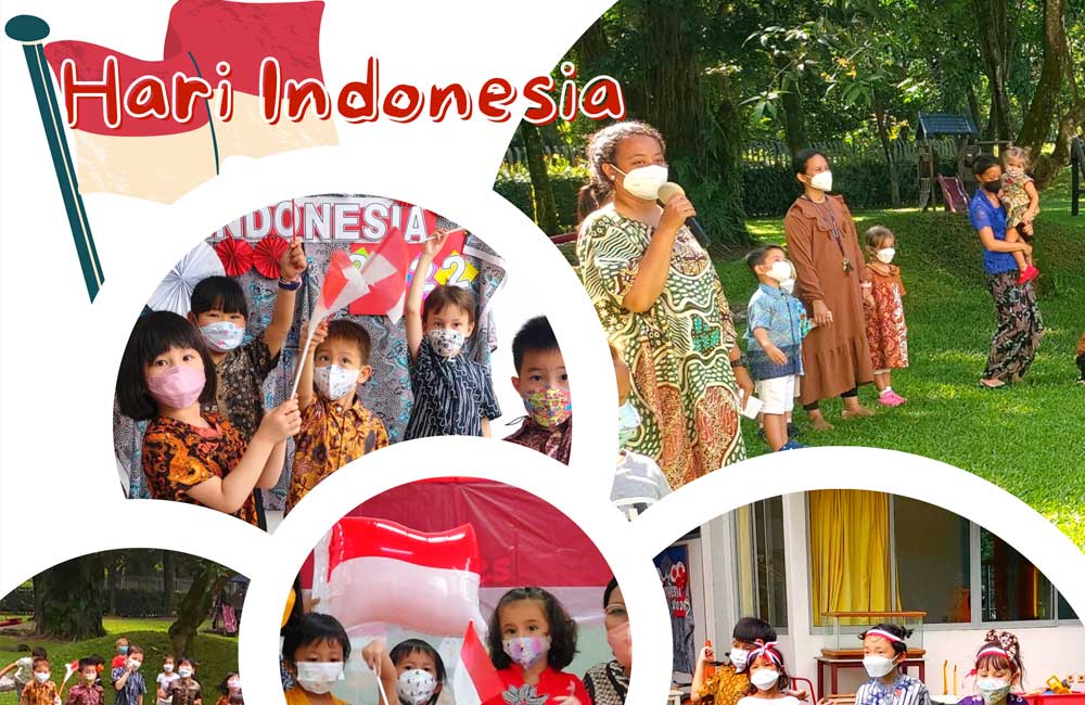 A group of children wearing face masks are holding flags and umbrellas.
