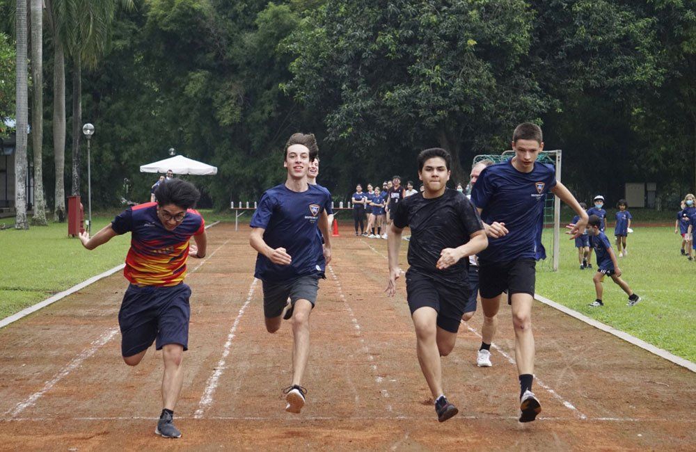 A group of young men are running on a track.