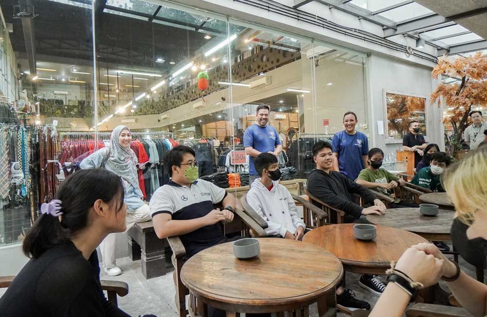A group of people are sitting at tables in a restaurant.