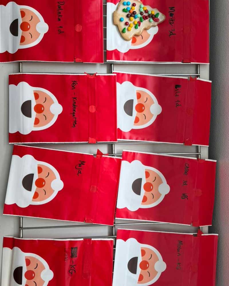A bunch of red bags with santa faces on them