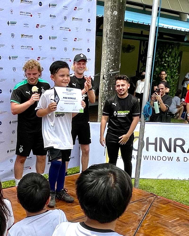 A group of people are standing in front of a sign that says window and door.