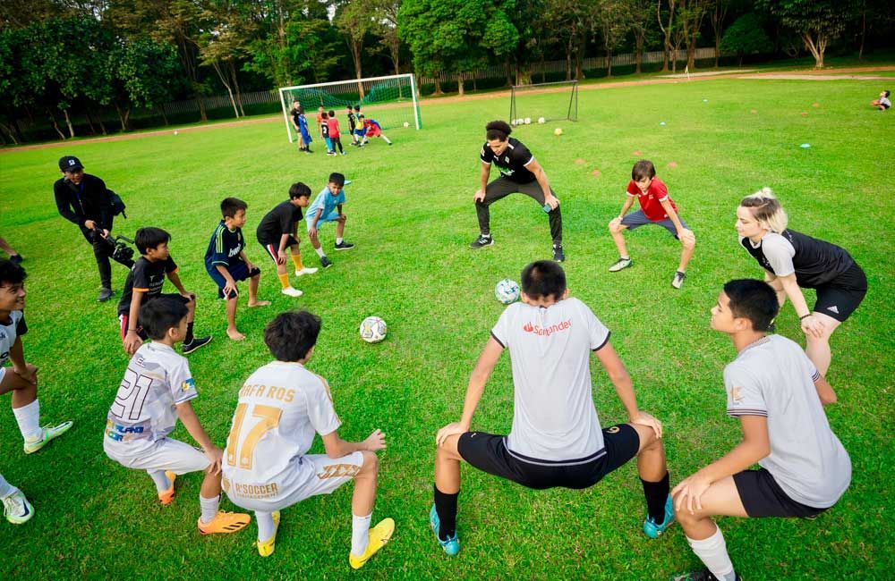 A group of young boys are playing soccer on a field.