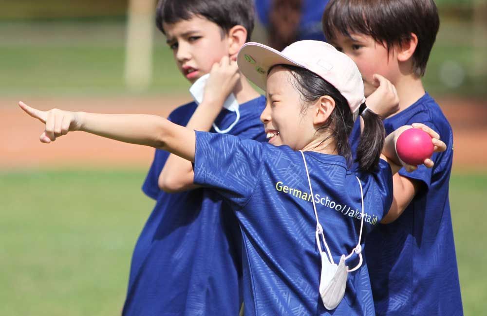 A group of children are playing with a ball on a field.