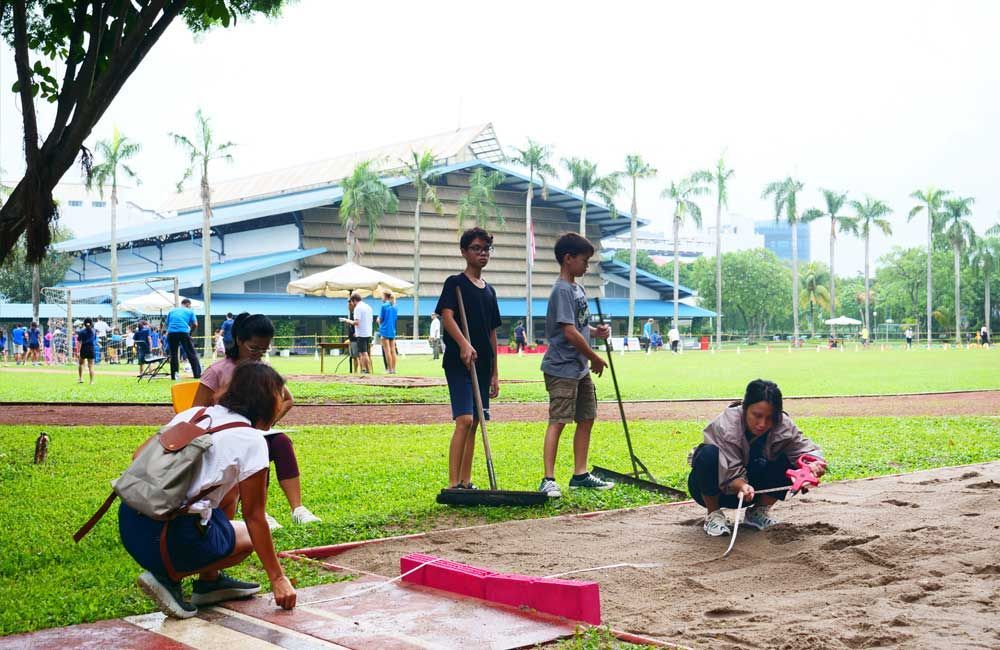 A group of people are cleaning a field in a park.