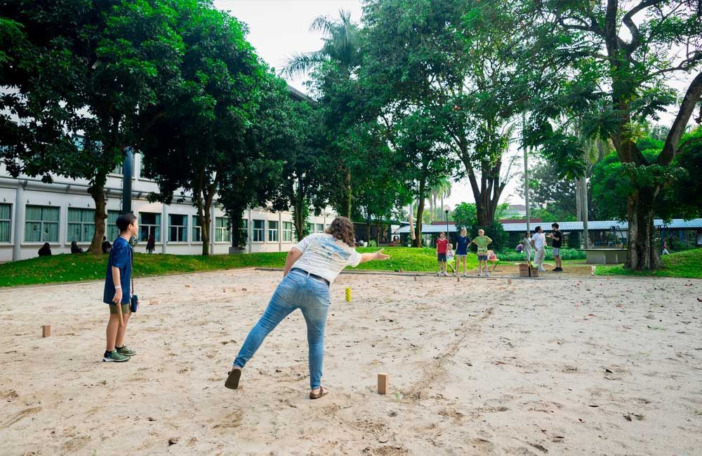 A group of people are playing a game of volleyball in a park.
