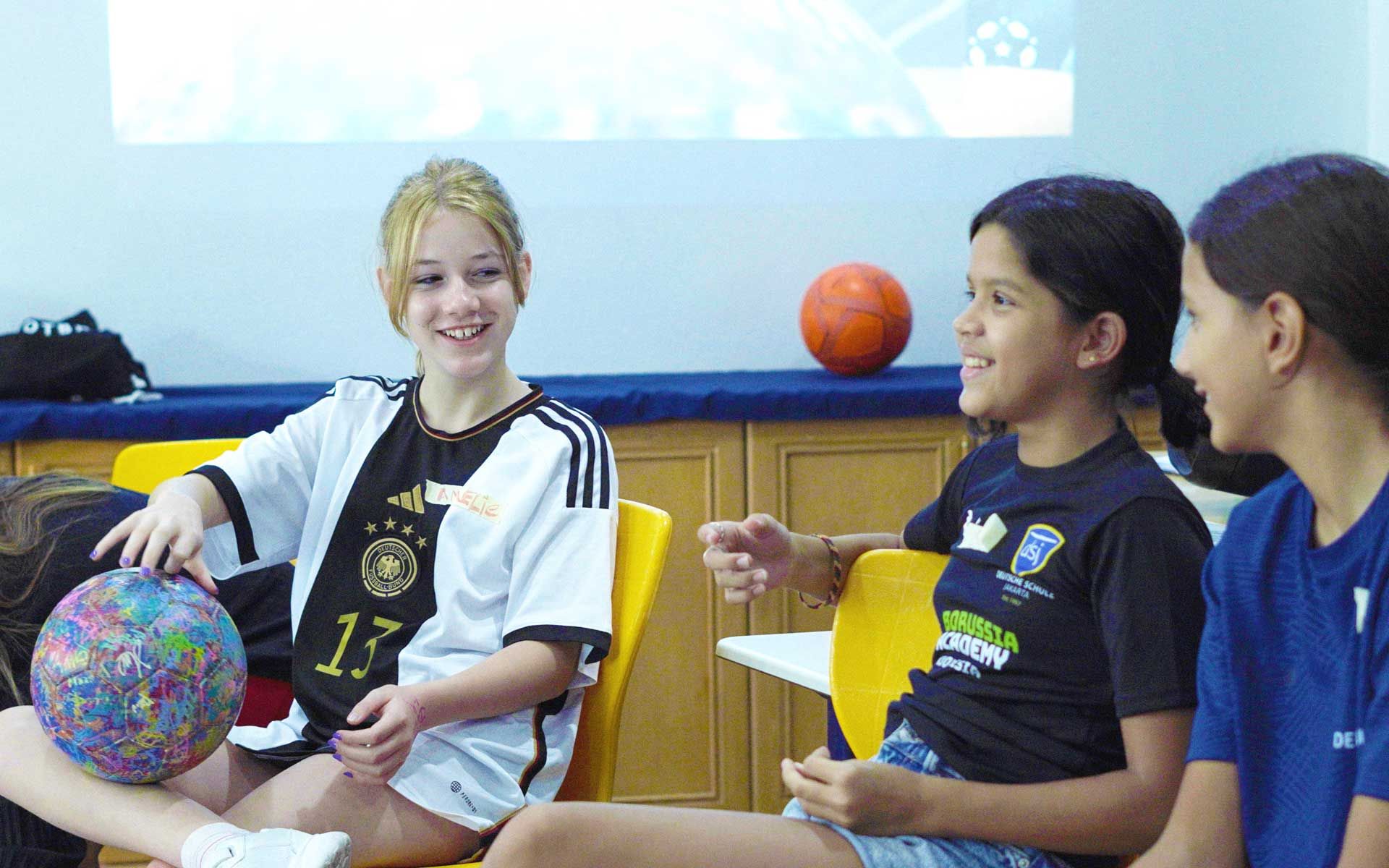 A girl wearing a jersey with the number 13 on it