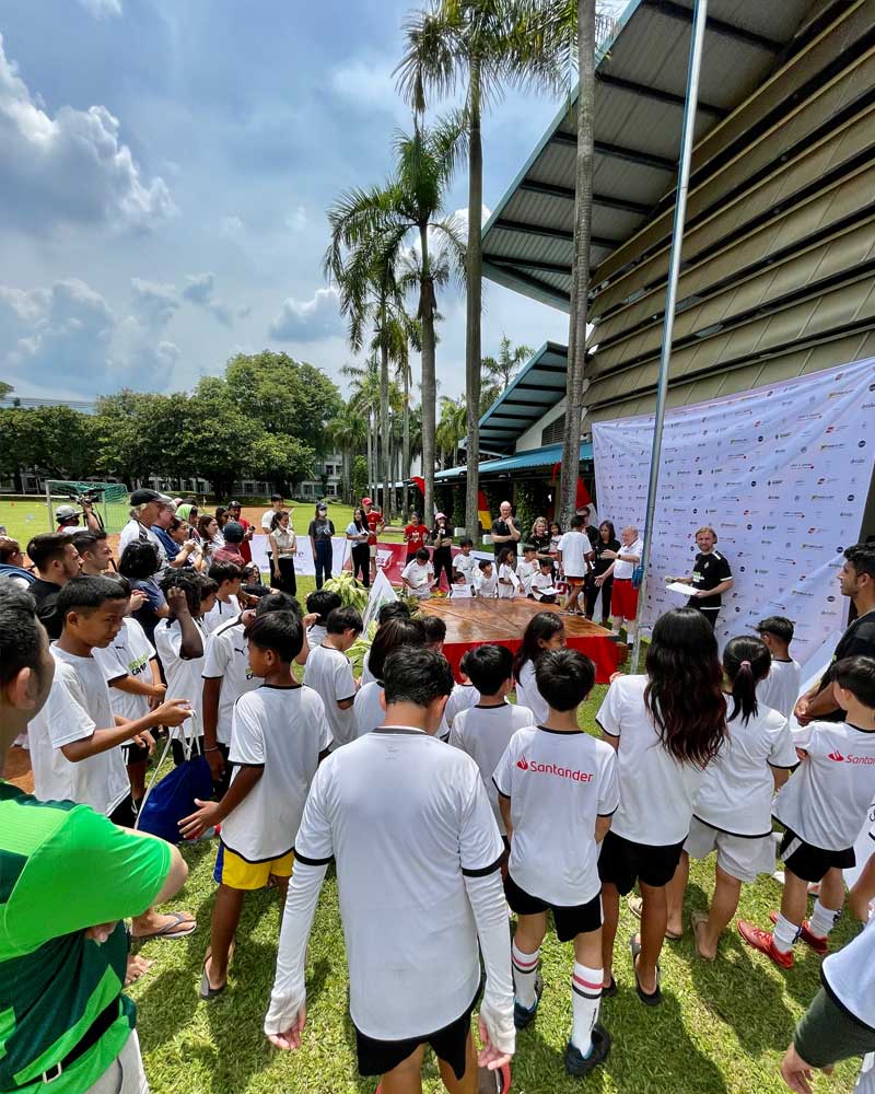 A large group of people are standing in a field.