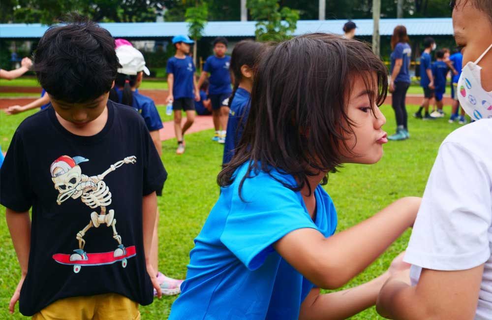 A girl wearing a blue shirt with a skeleton on it