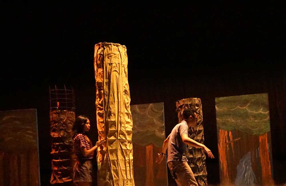 A man and a woman are standing next to each other on a stage.