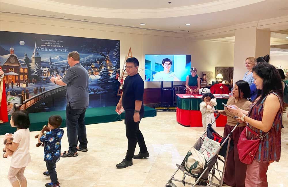 A group of people are standing in a room.