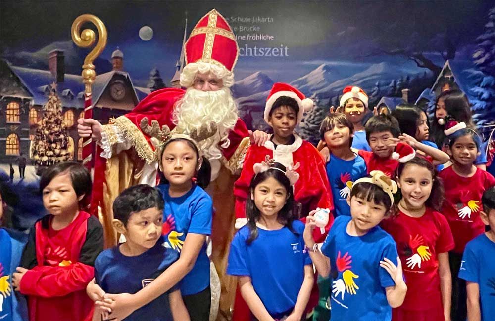 A group of children are posing for a picture with santa claus.