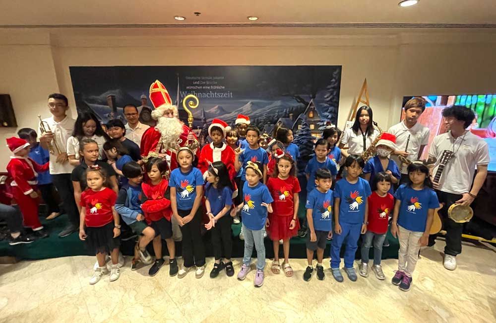 A group of children are posing for a picture with santa claus.