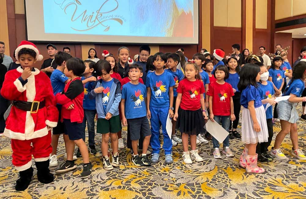 A group of children are posing for a picture with santa claus.