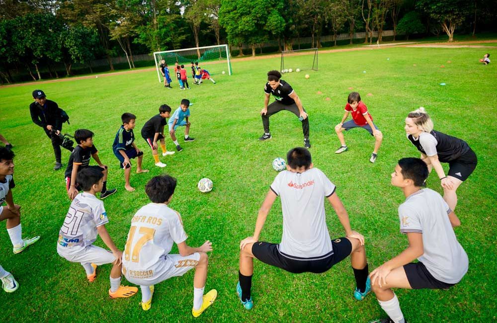 A group of young boys are playing soccer on a field.