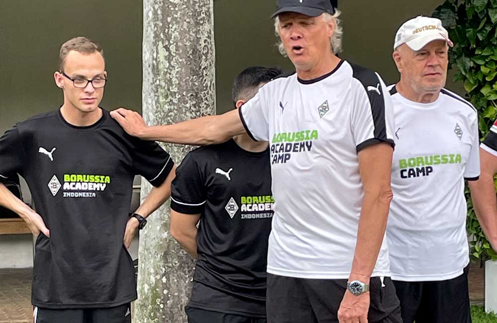 A group of men wearing black and white shirts are standing next to each other.