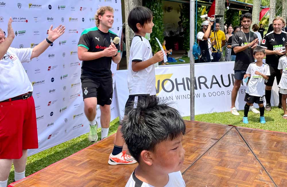 A group of people are standing on a wooden stage.