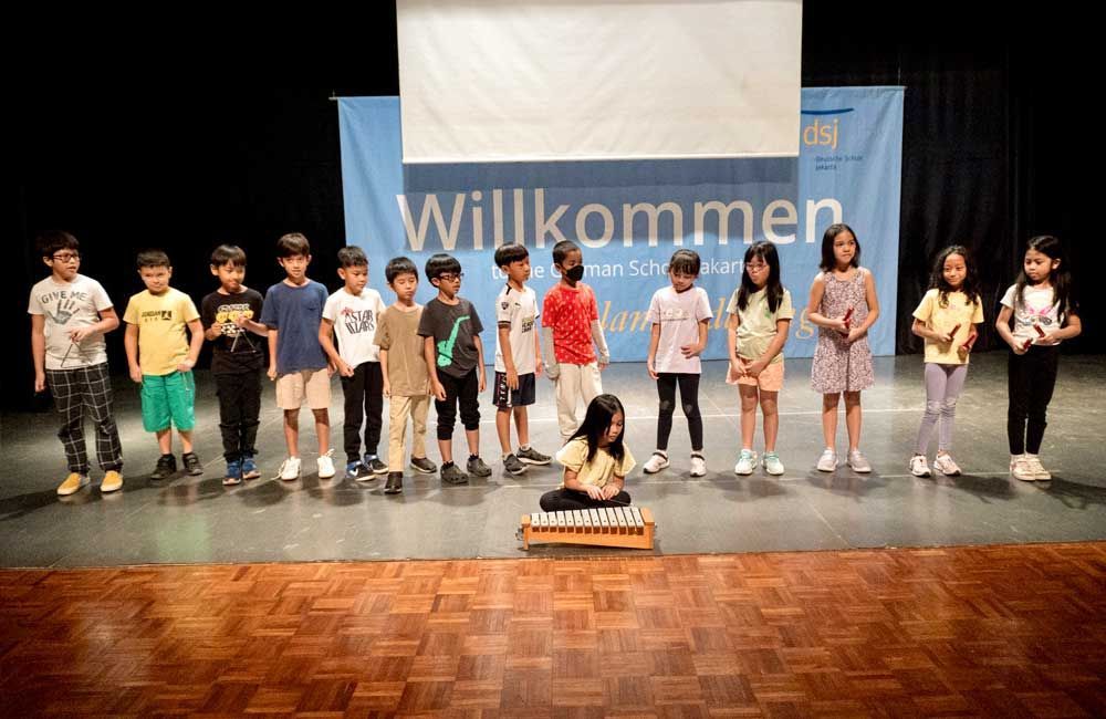 A group of children are standing on a stage.