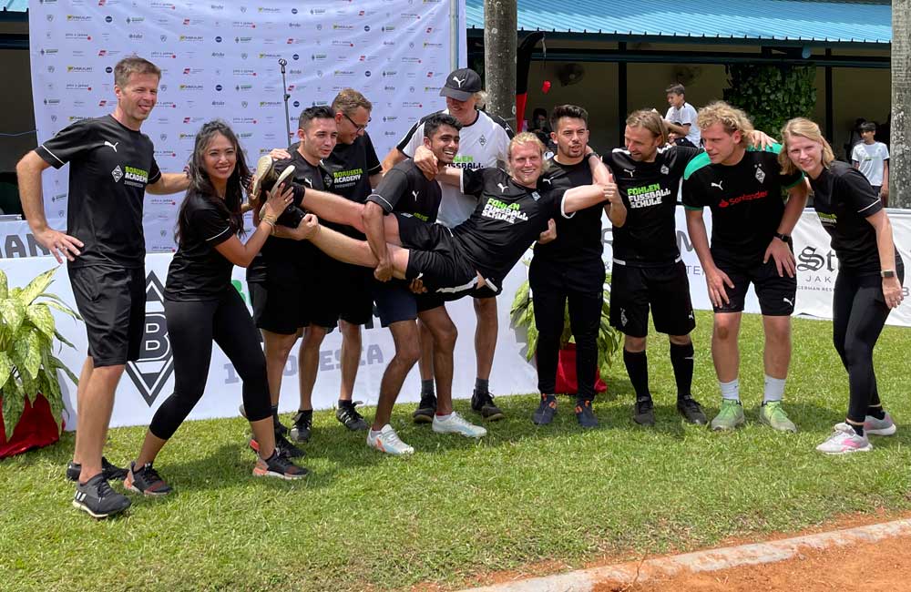 A group of people are posing for a picture in a field.