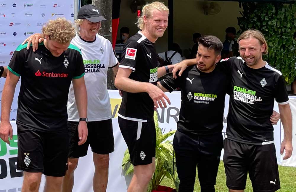 A group of soccer players are posing for a picture