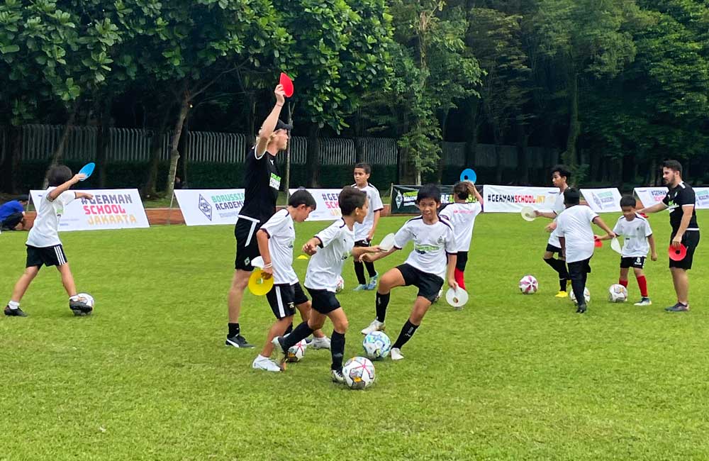 A group of young boys are playing soccer on a field.