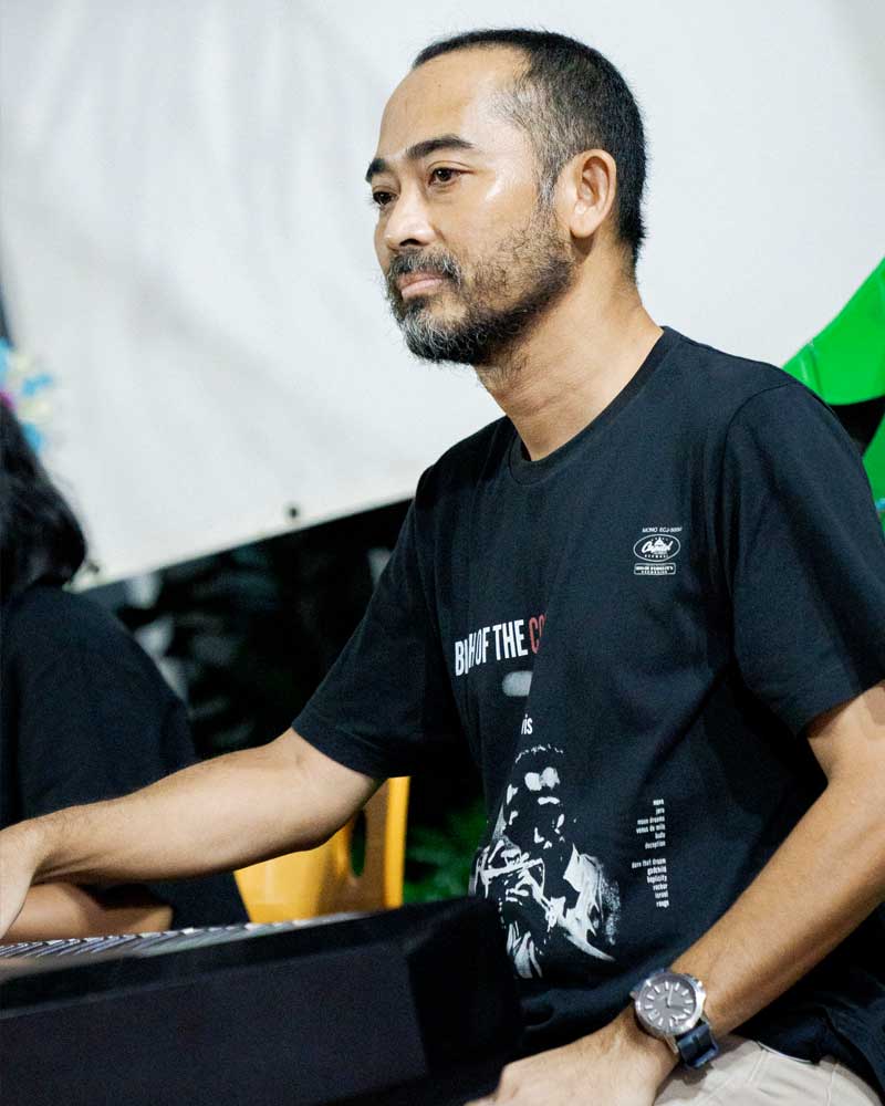 A man wearing a black shirt that says until i die