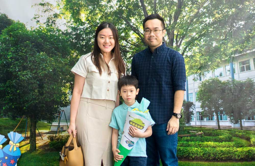 A family is posing for a picture in front of a building.