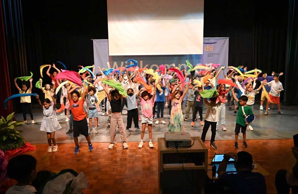 A group of children are dancing on a stage.