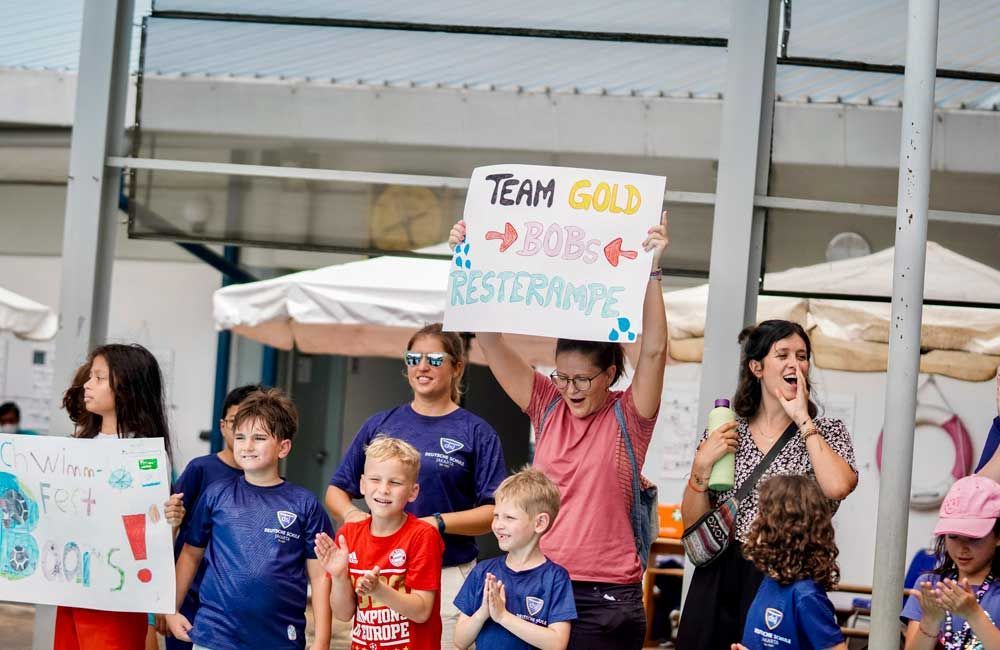 A group of people are holding signs that say team gold.