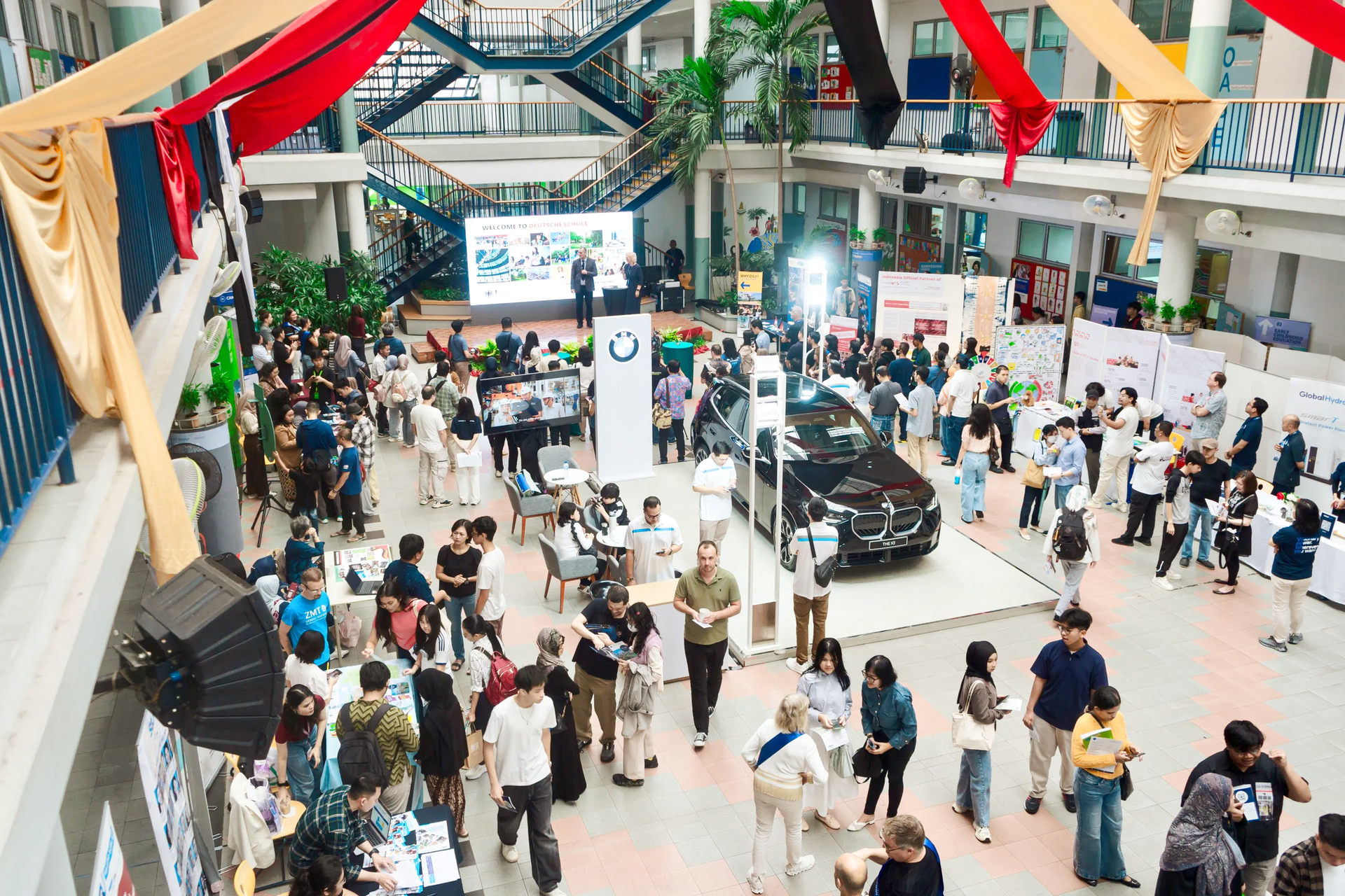 Curly hair student holding books in front of university