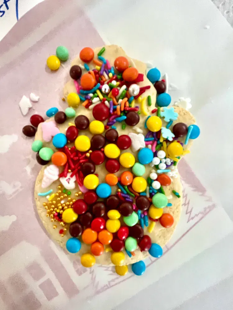 A piece of white chocolate covered in candy and sprinkles