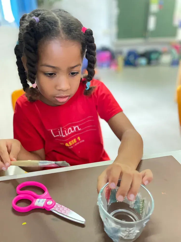 A little girl in a red shirt with the name lilian on it