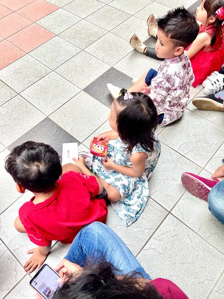 A group of children are sitting on the floor.