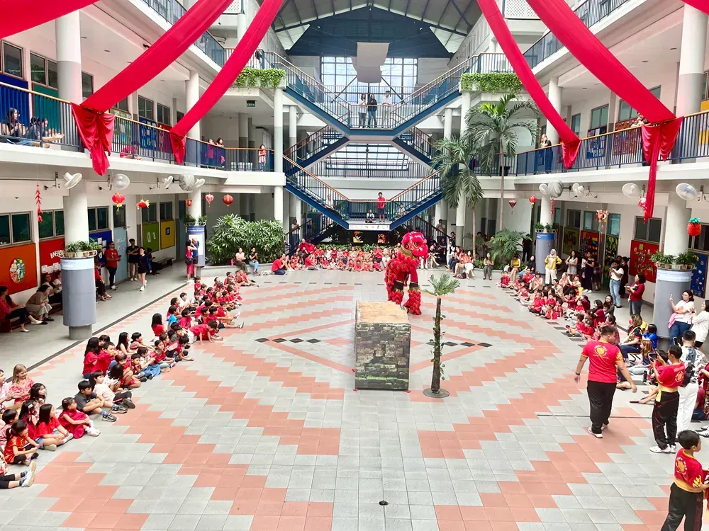 A large group of people are gathered in a large building.