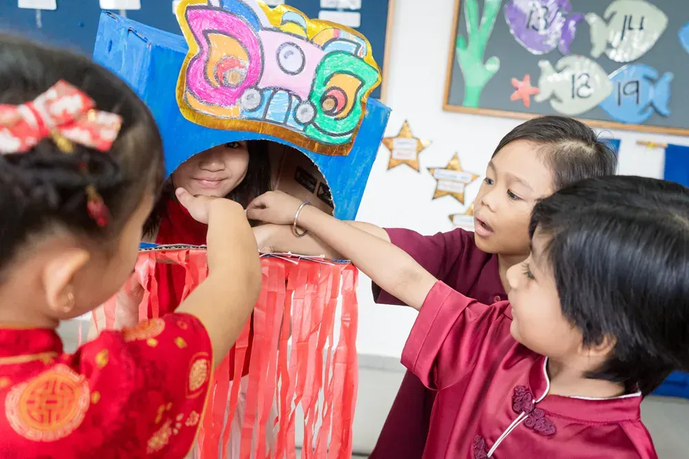 A group of children are playing a game in a classroom.